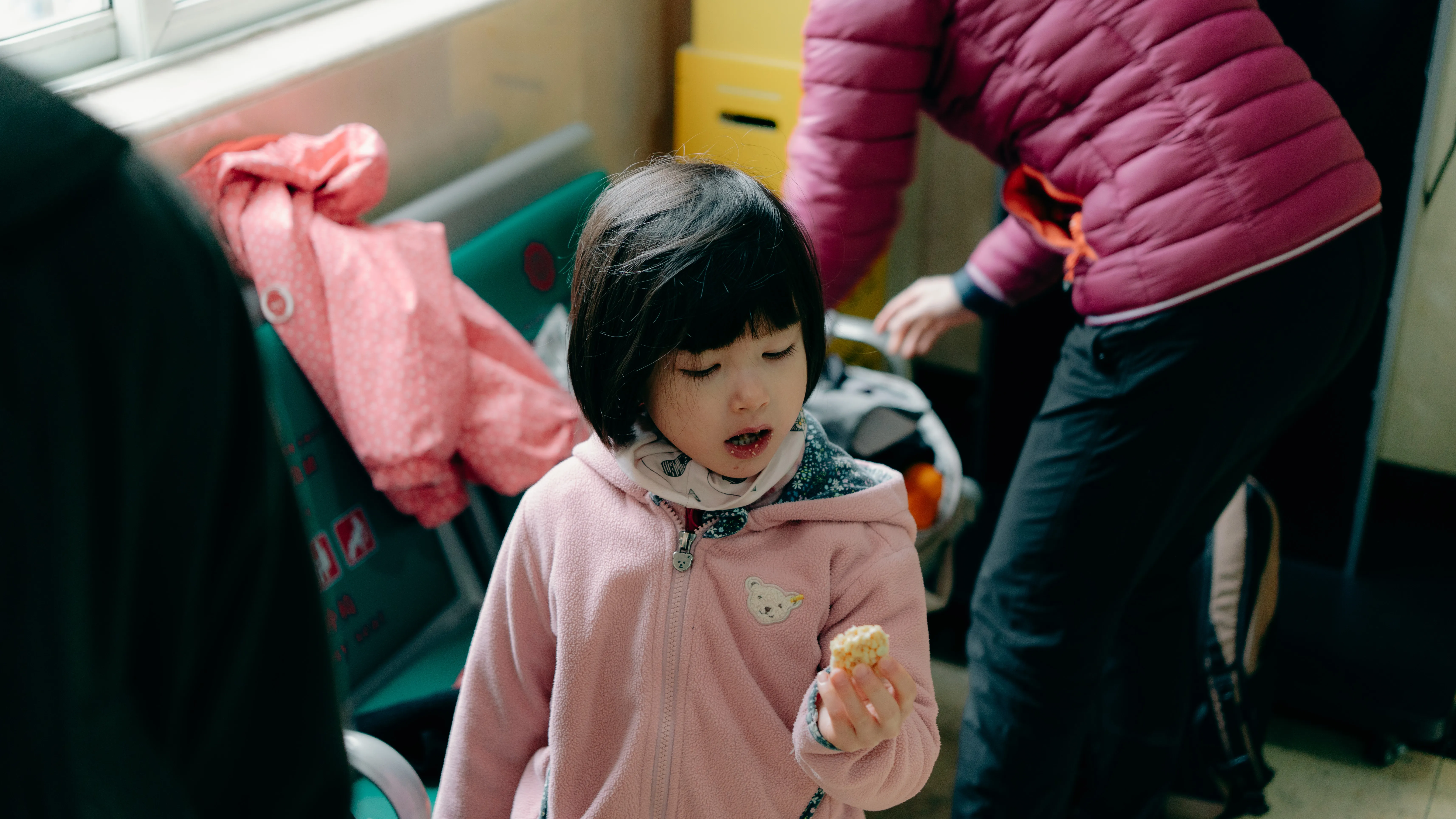 A child with a snack, waiting room in warm afternoon light