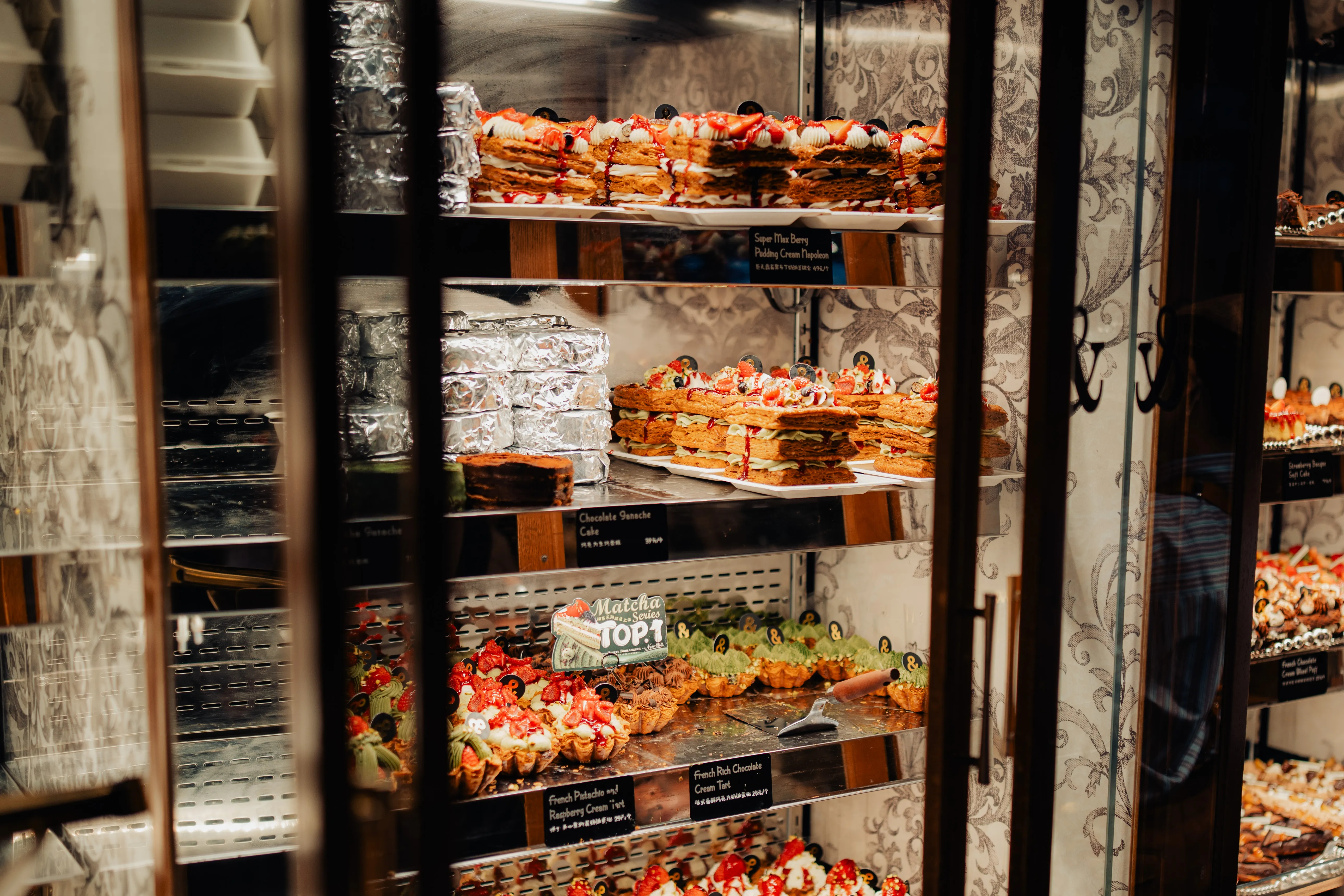 Pastries behind the glass of a late-night patisserie