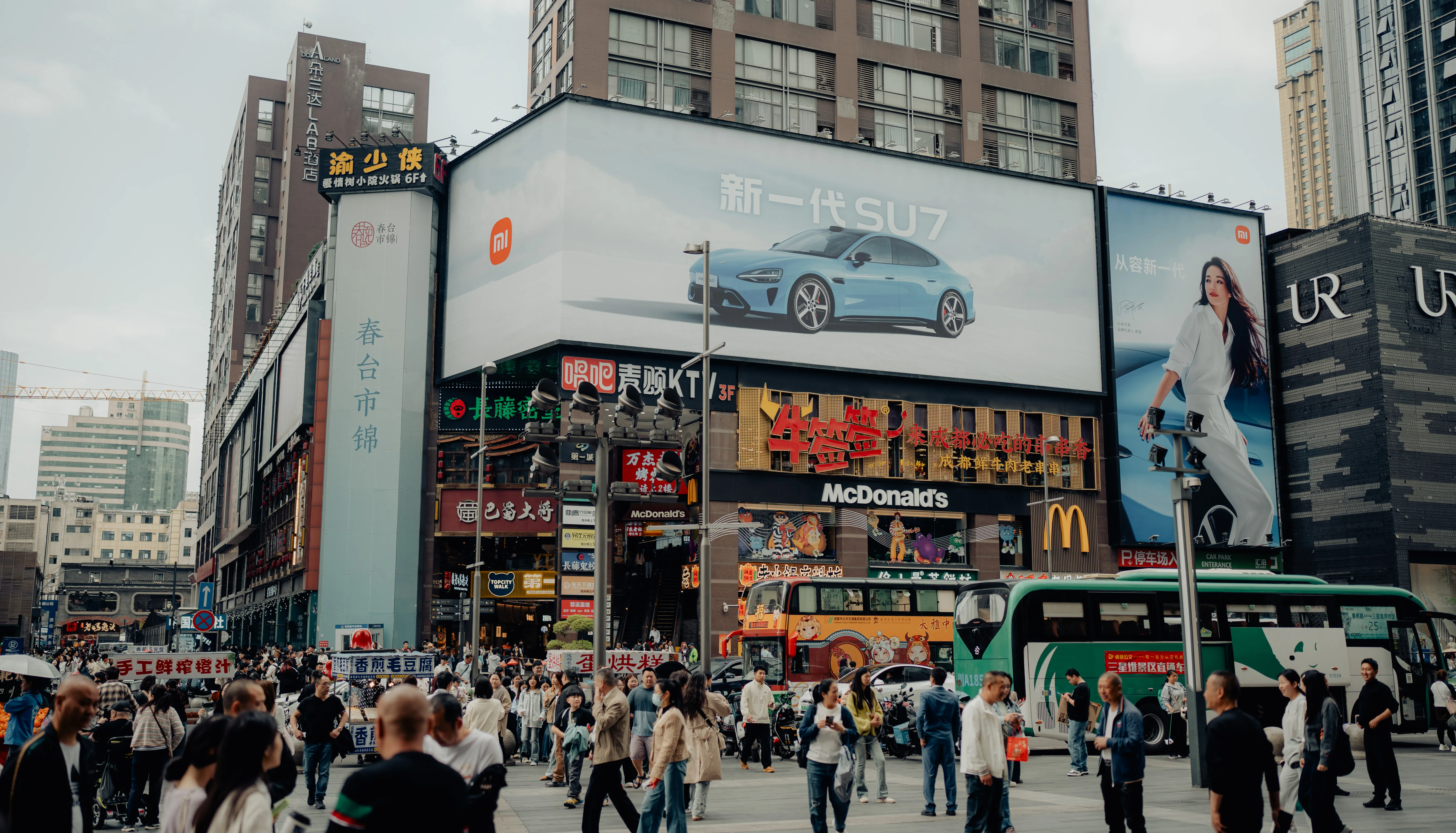 Neon billboards over a busy crossing in the old downtown