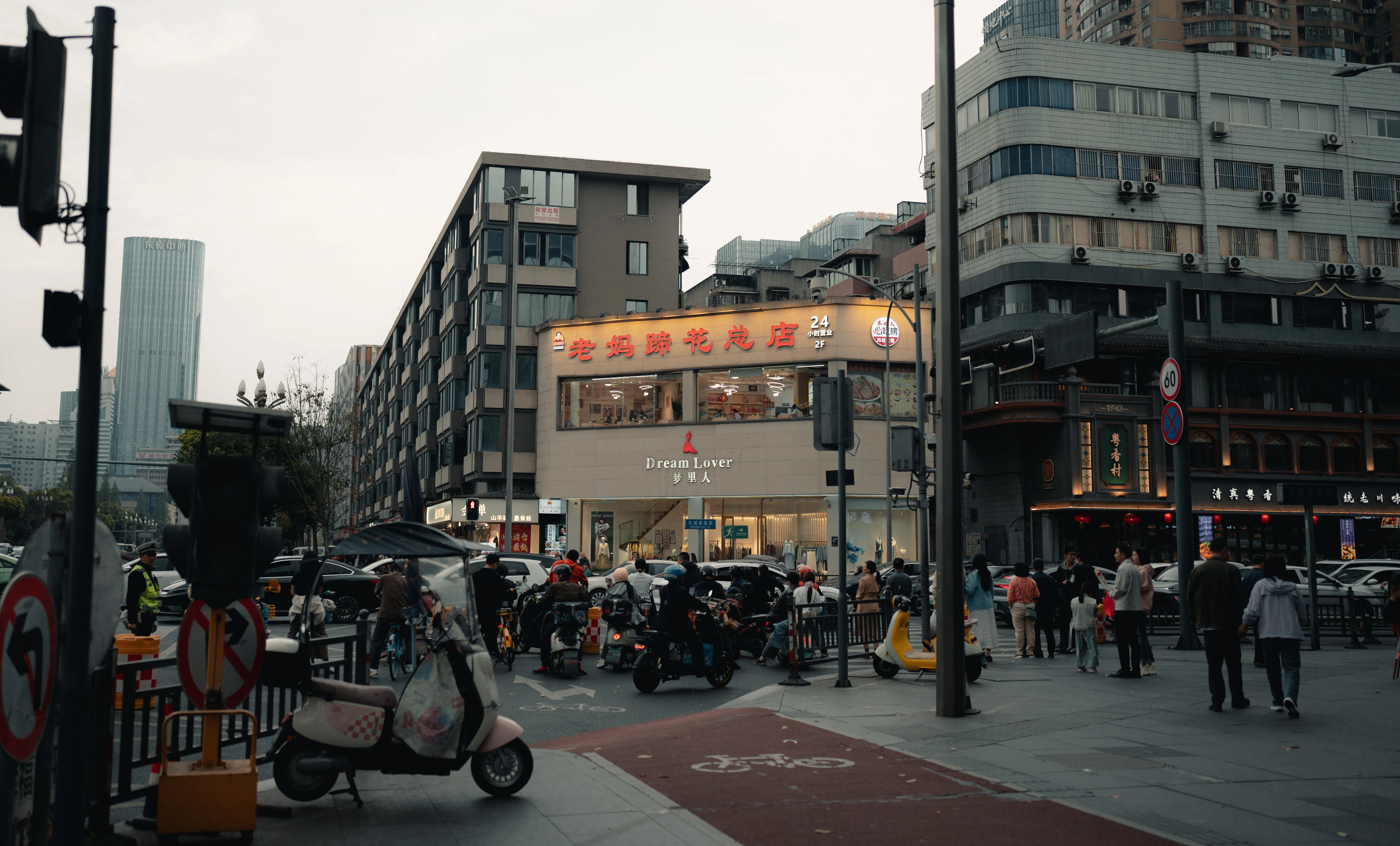 Scooters waiting at a flower-shop corner in overcast light